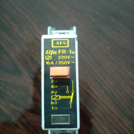 Image of an 831-788-077 AEG ELFA FR-1w Coil, a cylindrical electrical component, typically black or dark with visible copper windings.